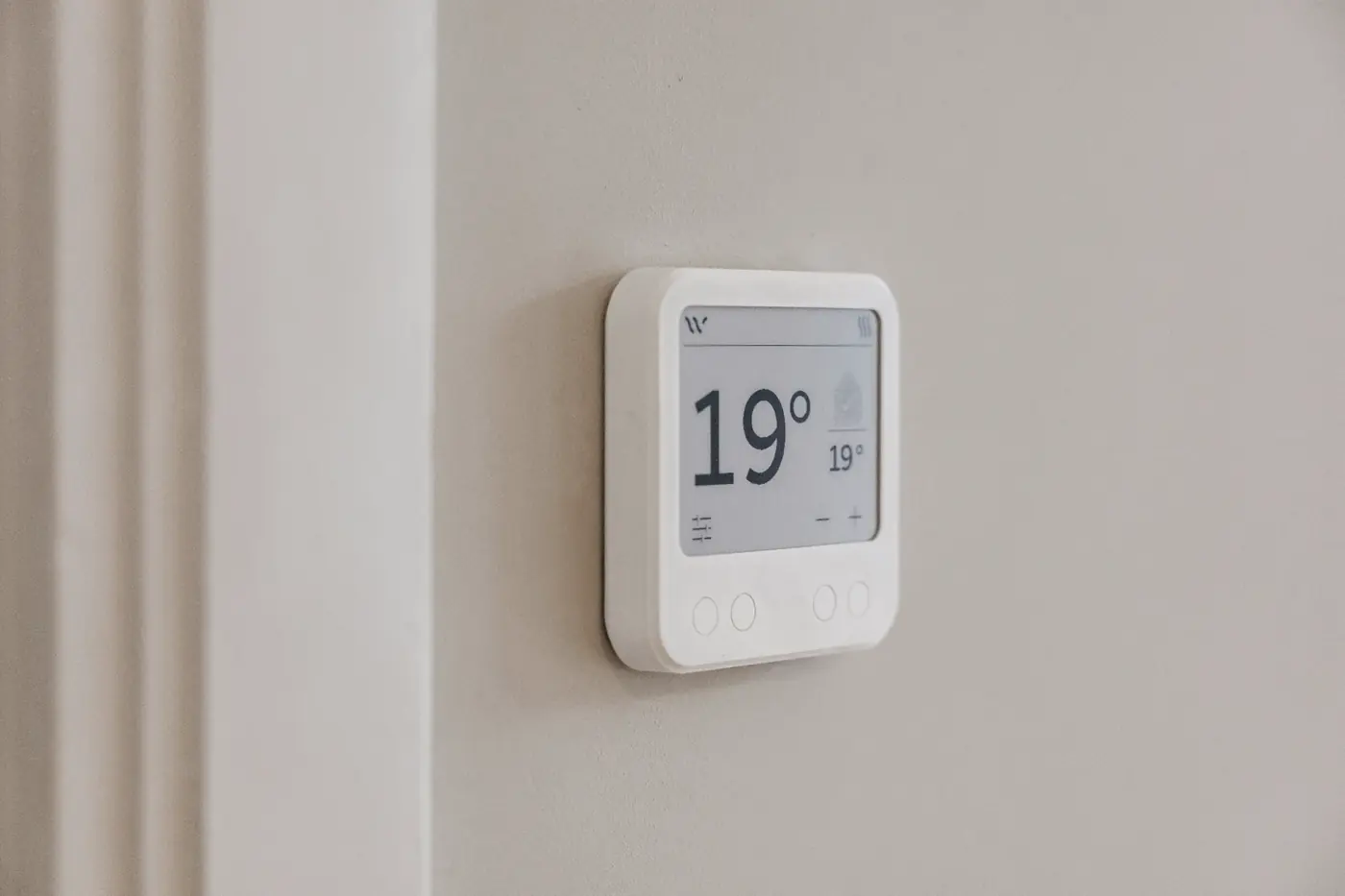 De meegeleverde Whspr-thermostaat aan de muur
